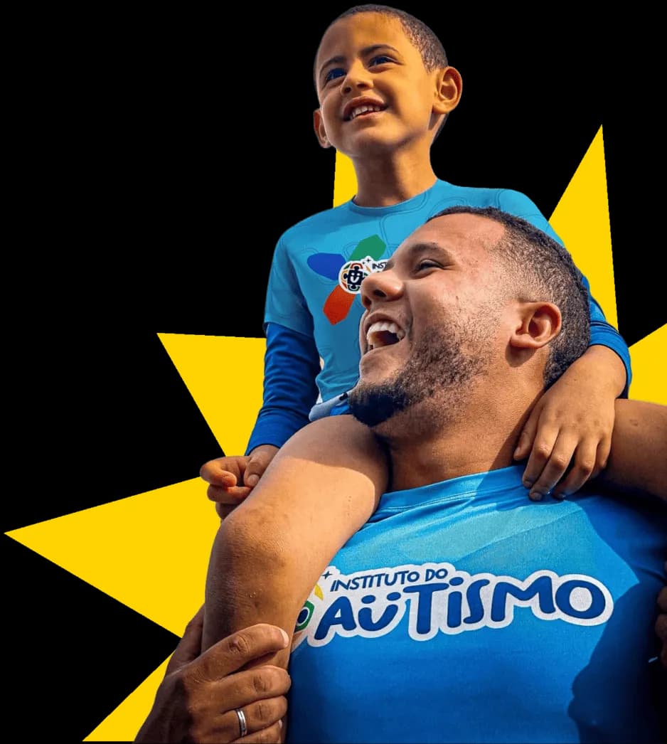 Menino sorrindo nos ombros de um terapeuta do Instituto do Autismo